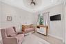 Neutral-toned interior featuring large-format ceramic tile flooring, a centered ceiling fan with integrated lighting, recessed ceiling lights, crown m