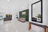 Polished tile flooring, recessed ceiling lighting, crown molding, a dark-toned accent wall, and built-in wall niches