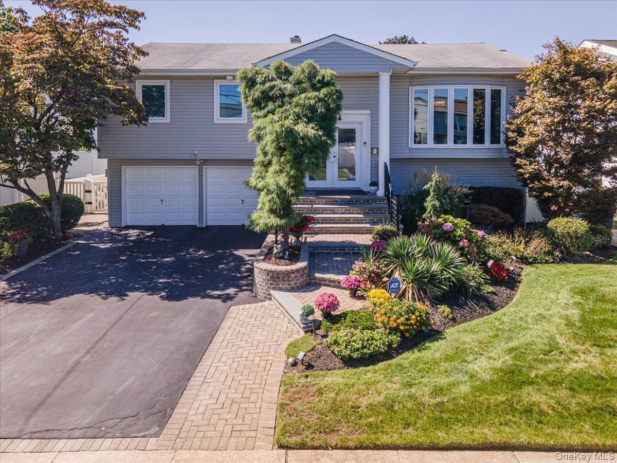 Professionally Landscaped, Paver Walkway to Staircase with Updated Railing
