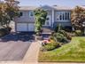 Professionally Landscaped, Paver Walkway to Staircase with Updated Railing