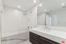 Bathroom with tub and dual van