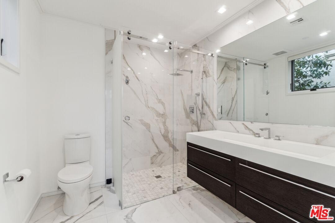 Bathroom with glass-enclosed s
