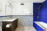 bath adjacent green bedroom