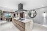 A sophisticated Italian-designed kitchen featuring custom cabinetry, premium Gaggenau appliances, gas cooking and an elegant island ideal for entertai