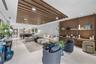 An expansive living room offering panoramic waterfront views and seamless access to the terrace.