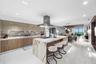A sophisticated Italian-designed kitchen featuring custom cabinetry, premium Gaggenau appliances, gas cooking and an elegant island ideal for entertai