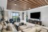 An expansive living room offering panoramic waterfront views and seamless access to the terrace.