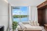 A private sitting area within the primary suite, perfectly positioned to enjoy the serene waterfront views.