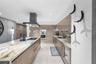 A sophisticated Italian-designed kitchen featuring custom cabinetry, premium Gaggenau appliances, gas cooking and an elegant island ideal for entertai