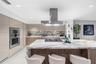 A sophisticated Italian-designed kitchen featuring custom cabinetry, premium Gaggenau appliances, gas cooking and an elegant island ideal for entertai