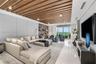 An expansive living room offering panoramic waterfront views and seamless access to the terrace.