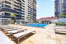 Resort-style pool deck offers abundant lounge seating, landscaped surroundings and shaded cabana-style retreats.