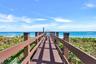 Direct community boardwalk leads through the dunes toward the Atlantic—putting Singer Island's beach lifestyle just steps from home.