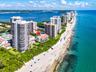 Aerial reveals Ocean House's intimate low-rise scale and its position immediately behind the beachfront dunes.