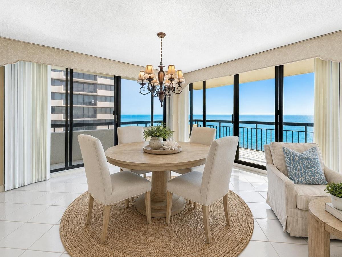 Ocean-facing dining is surrounded by glass, creating an extraordinary backdrop for everyday meals and entertaining. Virtually staged; furnishings and 