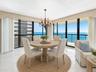 Ocean-facing dining is surrounded by glass, creating an extraordinary backdrop for everyday meals and entertaining. Virtually staged; furnishings and 