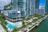 Spacious living area with wraparound windows and Miami skyline views