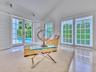 Walls of French doors fill the space with natural light