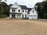 Beautiful colonial situated on level property surrounded by forever green.