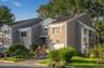 Front exterior view of this desirable end-unit townhouse, framed by mature landscaping