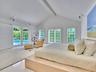 Walls of French doors fill the space with natural light
