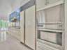 Volume Ceilings, French Doors, Wall of Windows and Dormers bring Natural Light into the Kitchen all day