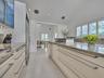 Volume Ceilings, French Doors, Wall of Windows and Dormers bring Natural Light into the Kitchen all day