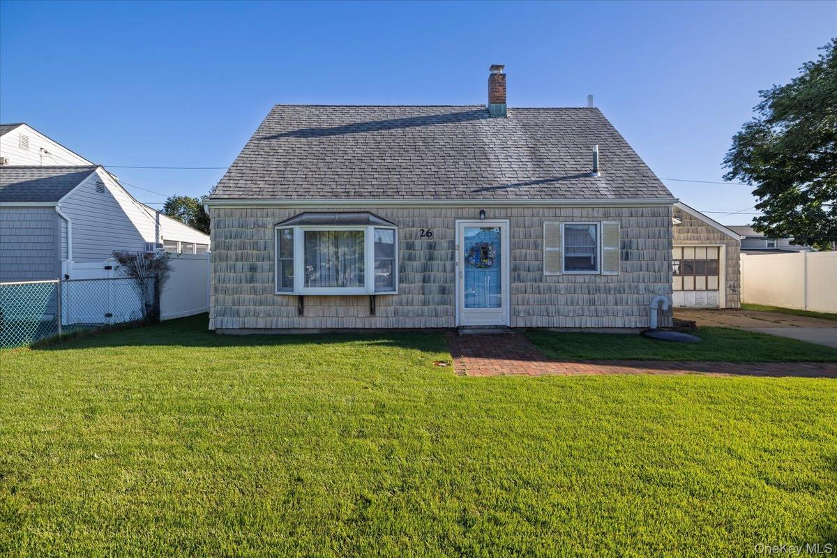 Front of home. Gabled roofline with shingle siding