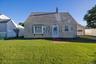 Front of home. Gabled roofline with shingle siding