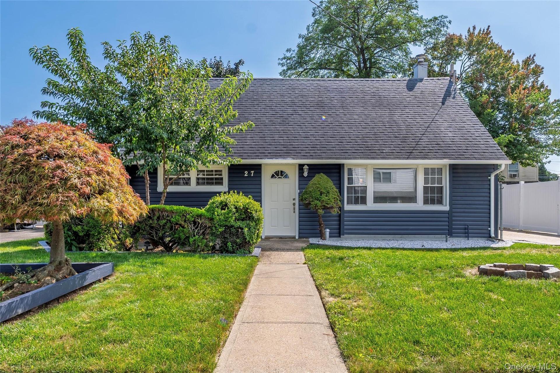 New Blue siding exterior with white trim windows and a white front door
