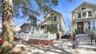 Picket fence with brick base, sunroom, and private driveway