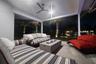 Outdoor kitchen with fire pit at night overlooks waterfront