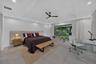 Oversized first primary bedroom with wide waterfront view