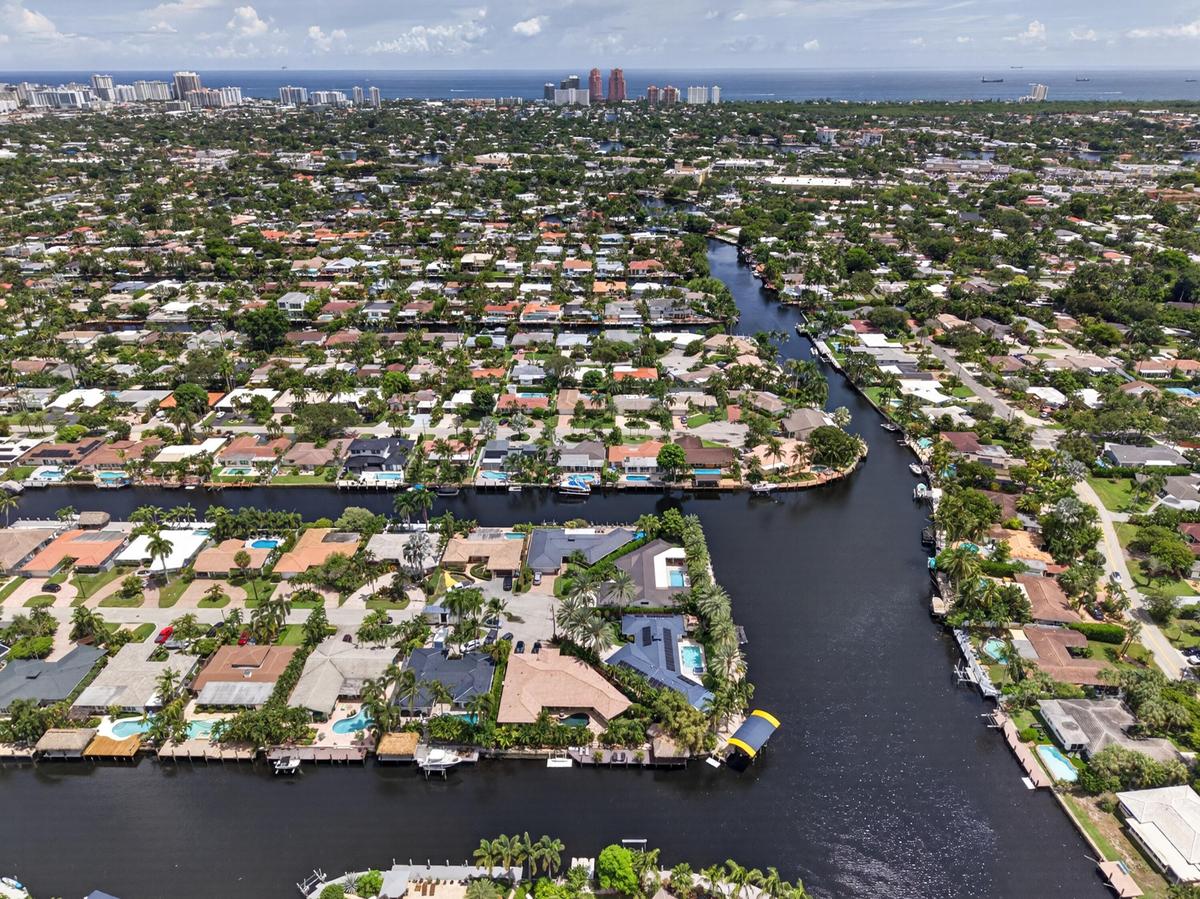 Aerial view Beautiful point lot home with wide waterfront for your boating enjoyment with Fort Lauderdale Beach in the background