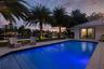 Pool at sunset with a view of the dock, and waterfront
