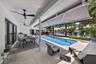Outdoor dining overlooking the pool and waterfront with remote control awning opened providing even more shade