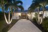 Front of home with wide private entrance with exterior lights leading to you large private foyer.