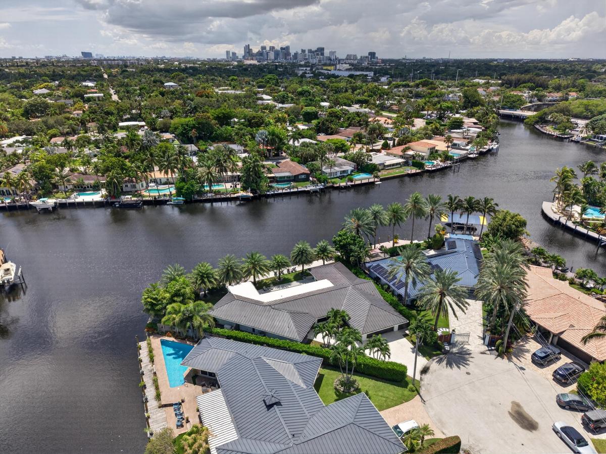 Aerial view of point lot waterfront home with view of downtown Fort Lauderdale