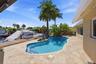 Waterfront Freeform Pool with Rock Waterfall adds to the Serene Waterfront Lifestyle.