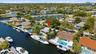 Your Future Home is located on a CANAL WITH OCEAN ACCESS & on a Quiet Street. 42' DOCK, 70' SEAWALL RESURFACED (2026) & NEW ALUMINUM ROOF (2024). No t