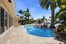Your Waterfront Freeform Pool with Rock Waterfall adds to the Serene Waterfront Lifestyle & is Surrounded by Beautiful Landscape.