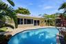 Beautiful Landscape Surrounds Your Waterfront Freeform Pool with Rock Waterfall adds to the Serene Waterfront Lifestyle.