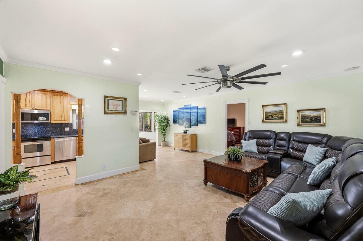 Spacious & Flexible Living Room,18" Travertine Tile Floors Throughout the entire home. IMPACT WINDOWS & DOORS!