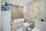 A beautifully finished primary bathroom featuring a relaxing soaking tub and refined marble-inspired details.