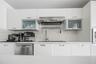 Sleek kitchen workspace featuring modern cabinetry, stainless-steel dishwasher, and contemporary sink area.