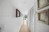 Bright hallway featuring clean lines, ample storage, and a beautiful view toward the pool.