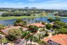 Aerial view showcasing the home’s prime water setting, surrounded by lush golf course landscapes and tranquil lake views.