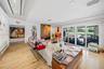 Spacious living area featuring modern recessed lighting, elegant flooring, and large sliding glass doors that provide abundant natural light and views