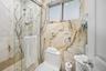 Modern full bathroom featuring marble-style finishes and a glass-enclosed walk-in shower. En-suite of Secondary Bedroom 1