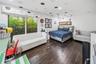 Bright and inviting secondary bedroom 2 with playful details, generous space, and beautiful garden views.